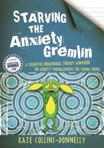 [The cover of 'Starving the Anxiety Gremlin' by Kate Collins-Donnelly shows a distressed green gremlin biting its nails against a blue swirling pattern background. The title appears in bold white letters with a badge indicating it is an award-winning book in the top left corner.]