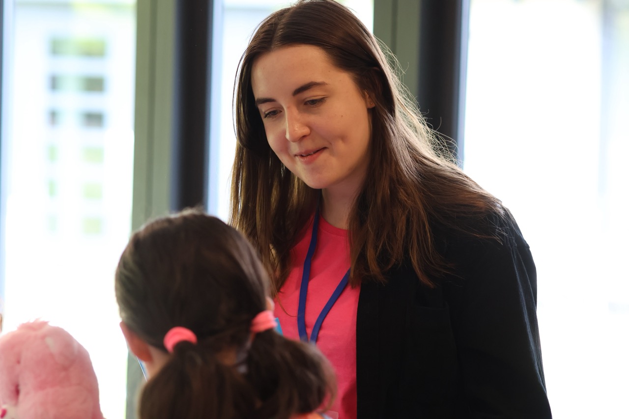 Photograph of PSC's Neurodivergent CYP Support Practitioner Anna talking to a young person